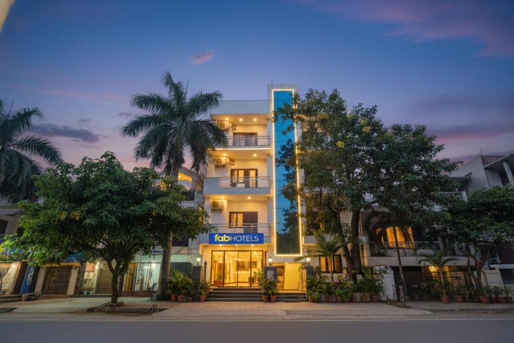 a building with trees in front of it at FabHotel Comfirt Inn in Noida