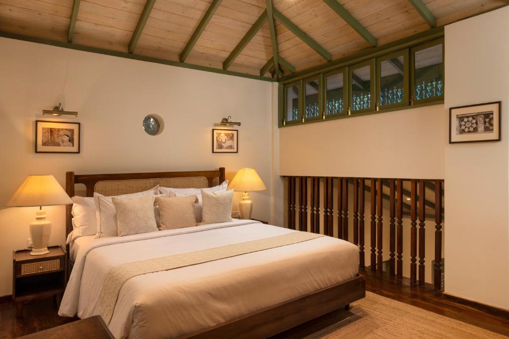 a bedroom with a large bed and two lamps at Ridee Kandy in Kandy