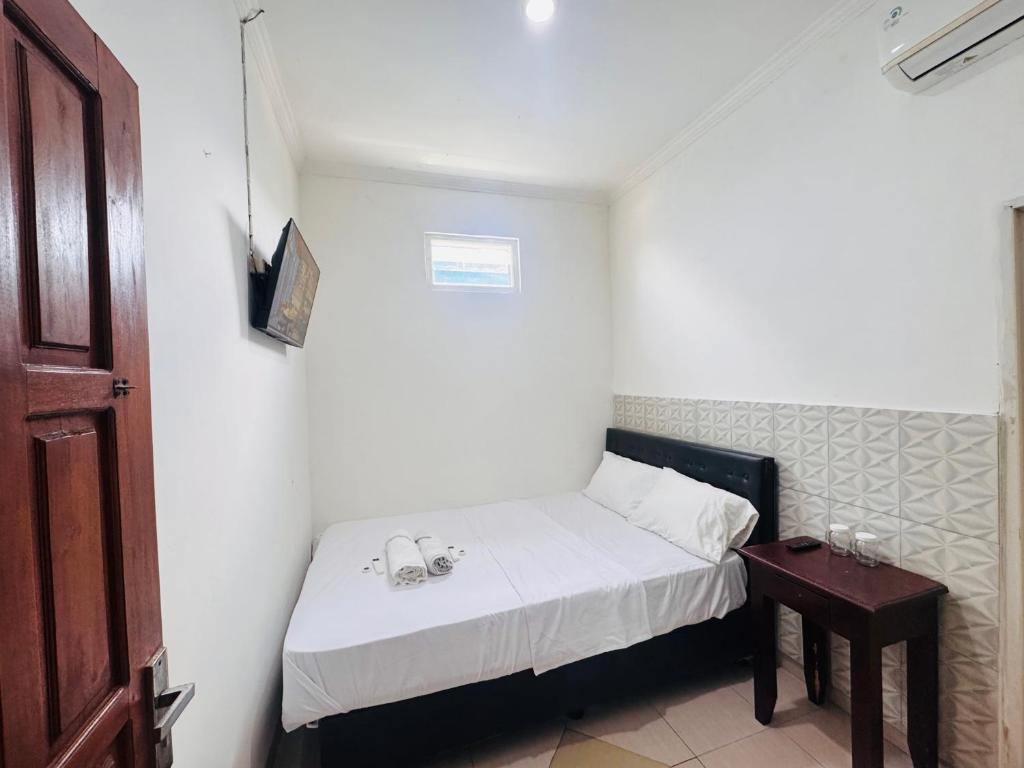 En eller flere senge i et værelse på CQA Living TANA 1 By ARBA