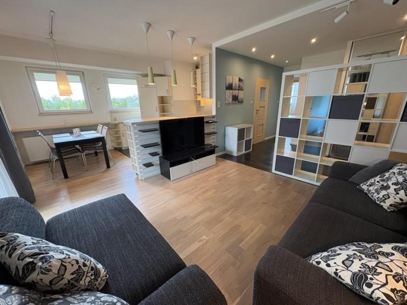 a living room with a couch and a table at Apartament przy szpitalu CZMP Łódź in Łódź