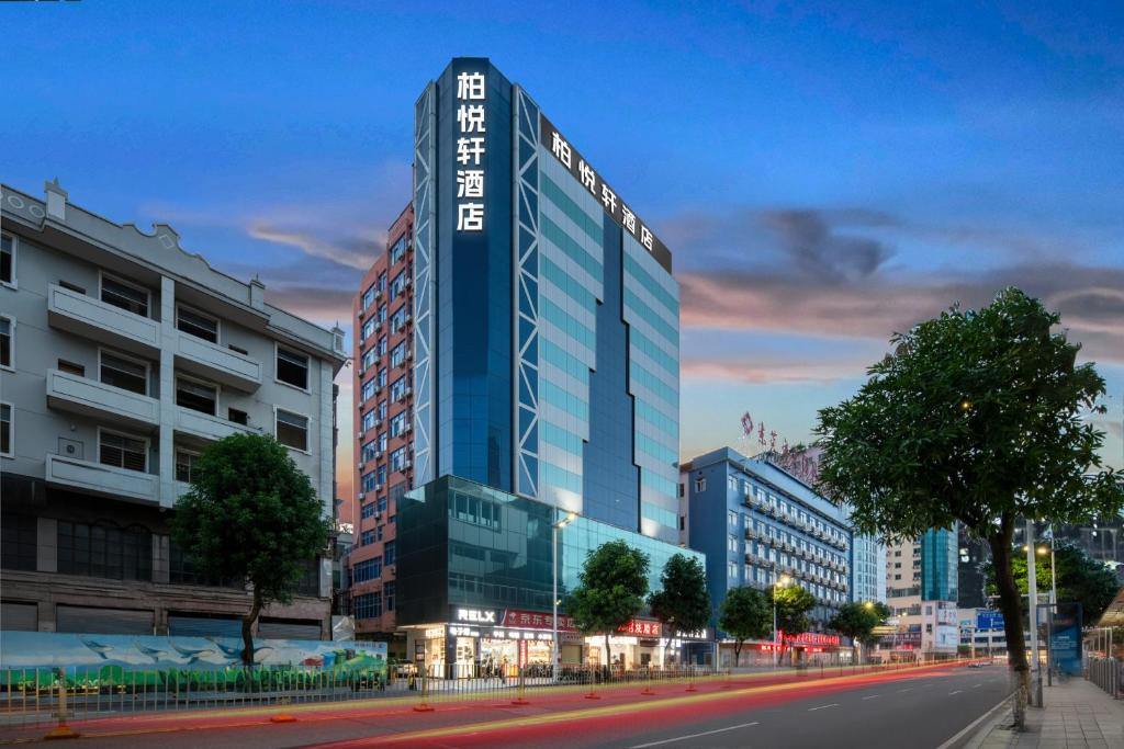 a tall blue building on a city street at Park Hyatt Hotel in Taiping