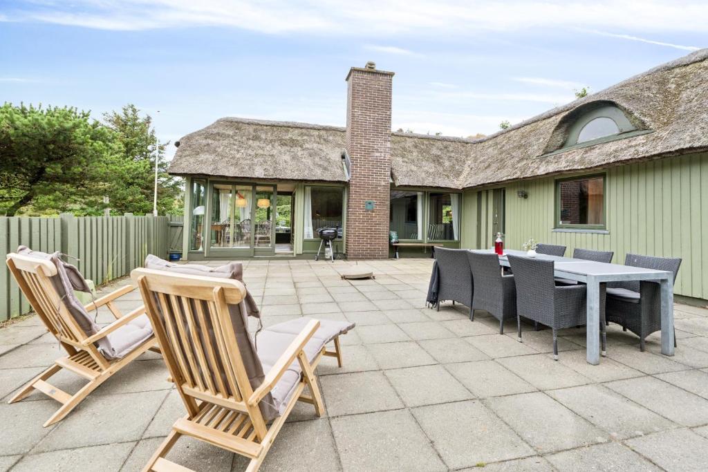 Feriehus 1140 في سوندرفيغ: فناء مع كراسي وطاولة ومنزل