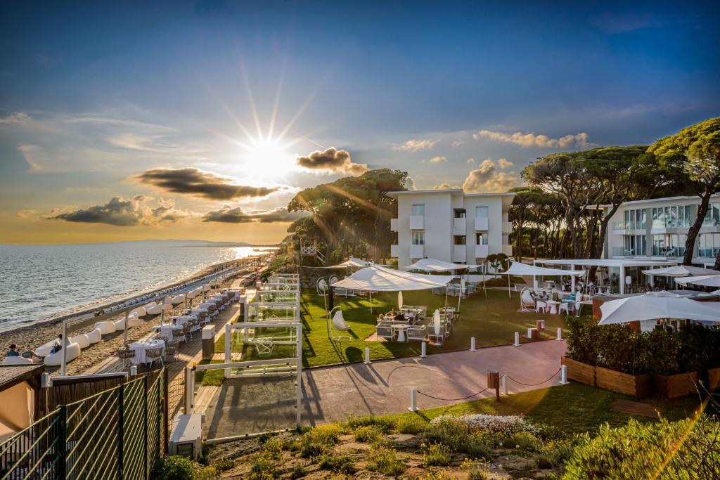 a view of a beach with a hotel and the ocean at The Sense Experience Resort - Preferred Hotels & Resorts in Follonica