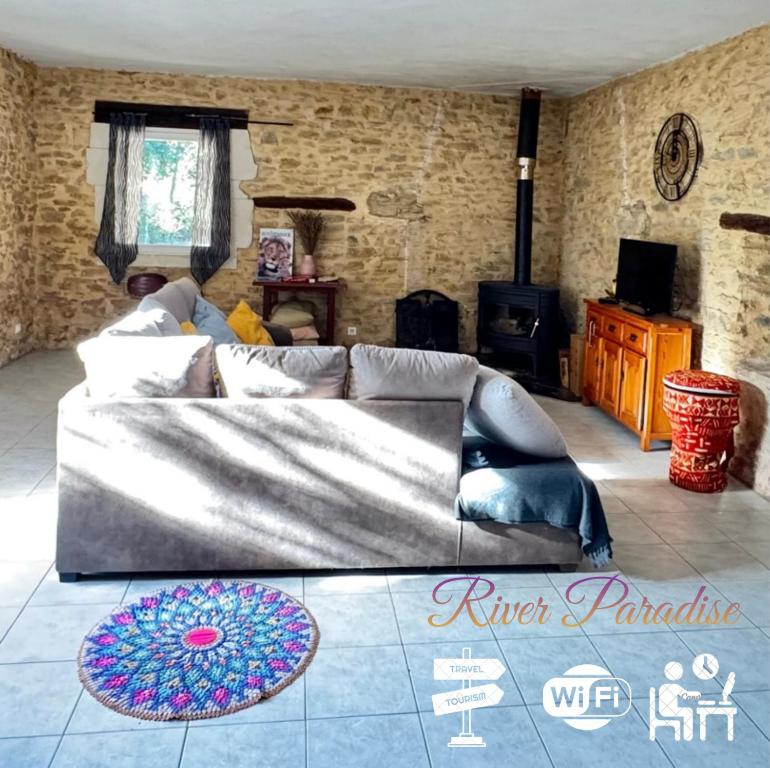 a living room with a couch and a table at VILLA RIVIERE in Bagnols-sur-Cèze
