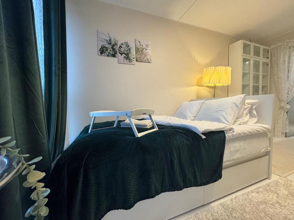 a white bed with a black blanket on it at I&A Residence - Roseni tn in Tallinn