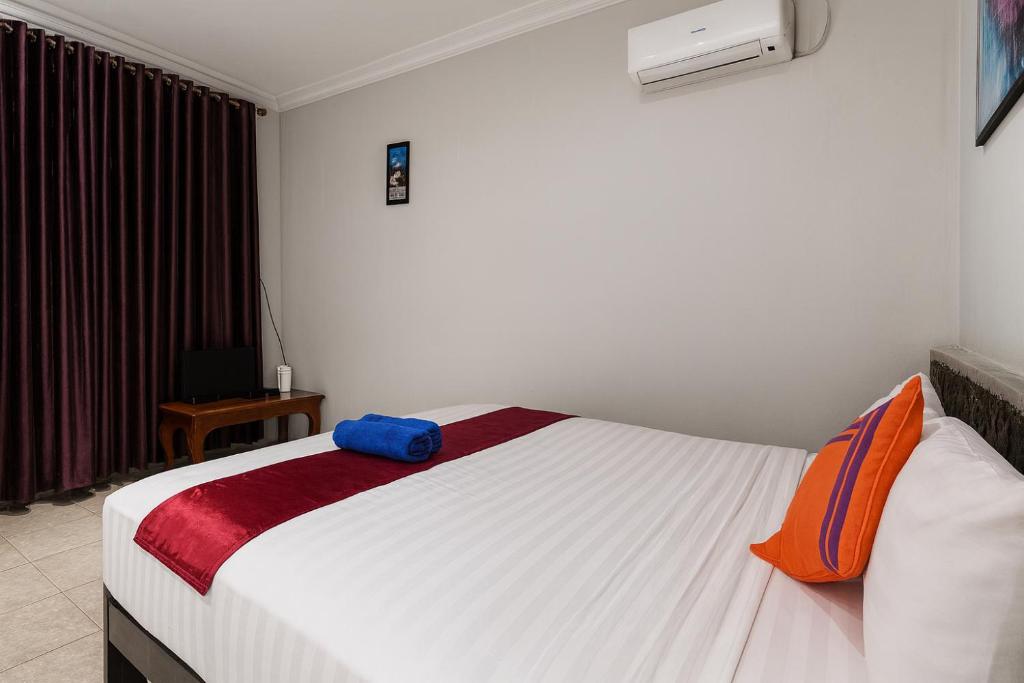 Ένα ή περισσότερα κρεβάτια σε δωμάτιο στο Cahaya Adrian Near Komodo Airport