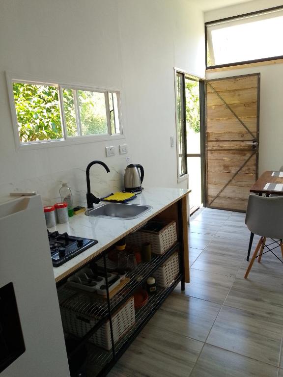 a kitchen with a sink and a counter top at Tiny House Potrero Cba in Potrero de Garay