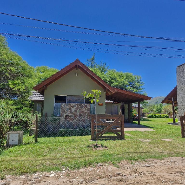 a small house with a tree in front of it at die lavendel chalet in Villa General Belgrano