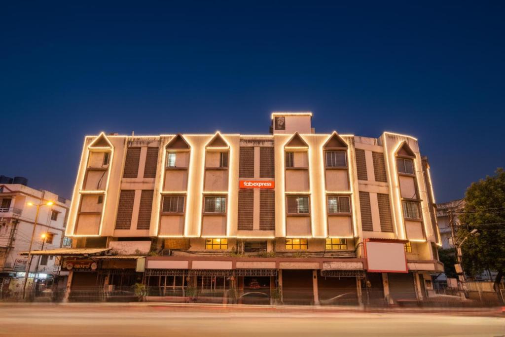 a large building on the corner of a street at Via Sai Lodging - Nashik Railway Station in Nashik