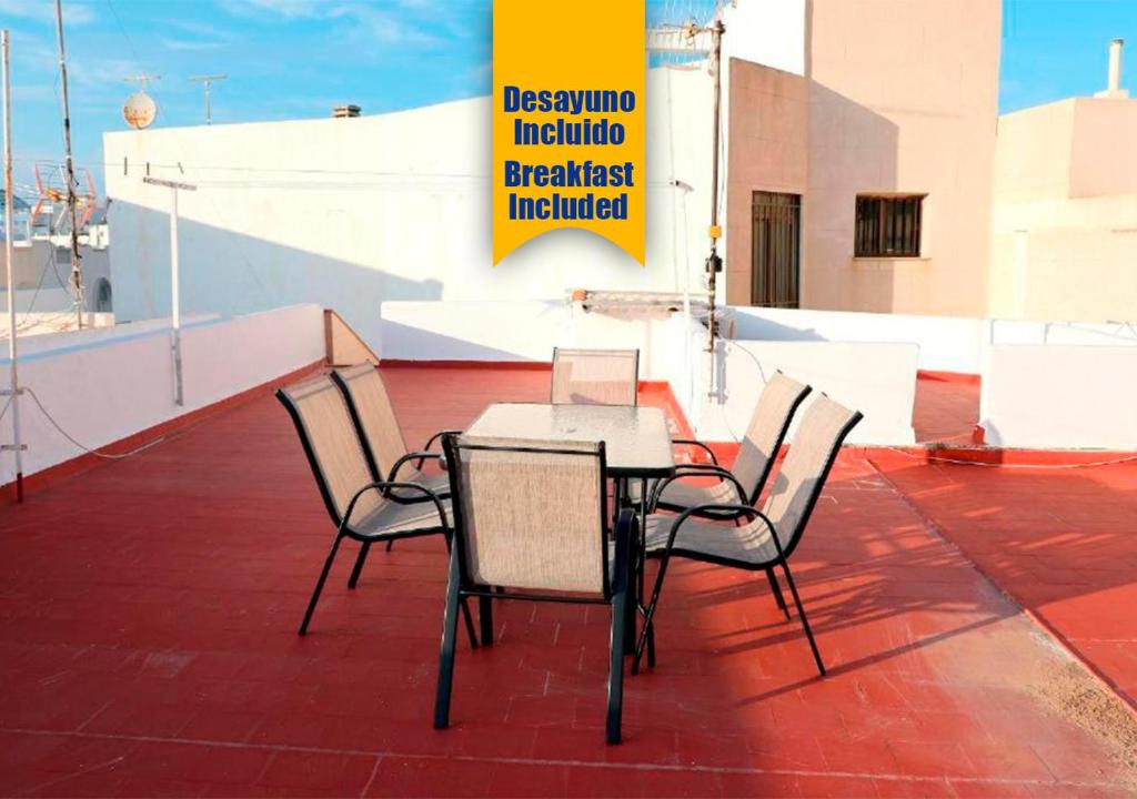 a table and chairs sitting on a patio at Apartalux Luna Carboneras in Carboneras
