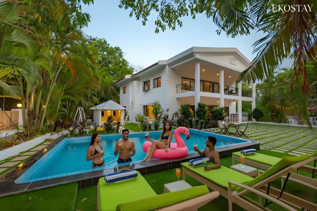 a group of people in a swimming pool in a house at Ekostay Luxe - CASA SIA - Ideal for Big Groups- Poker Table in Lonavala
