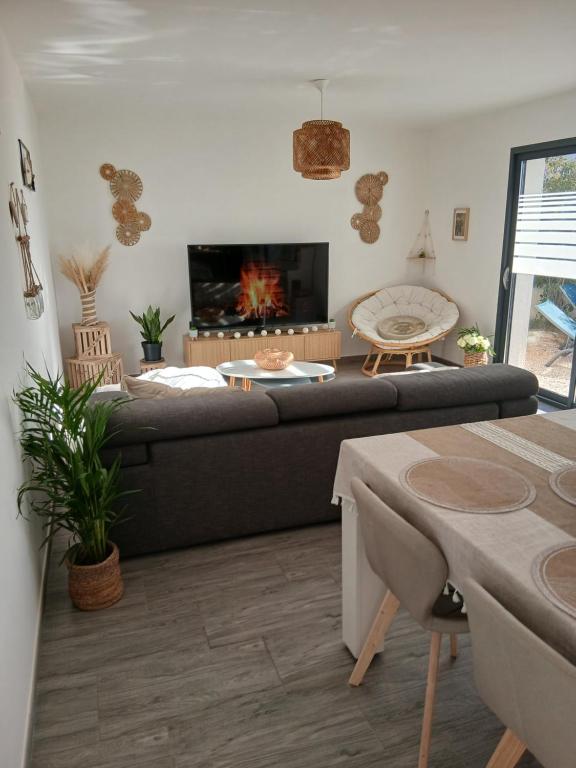a living room with a couch and a fireplace at Location Saisonnière Villa in Uzès