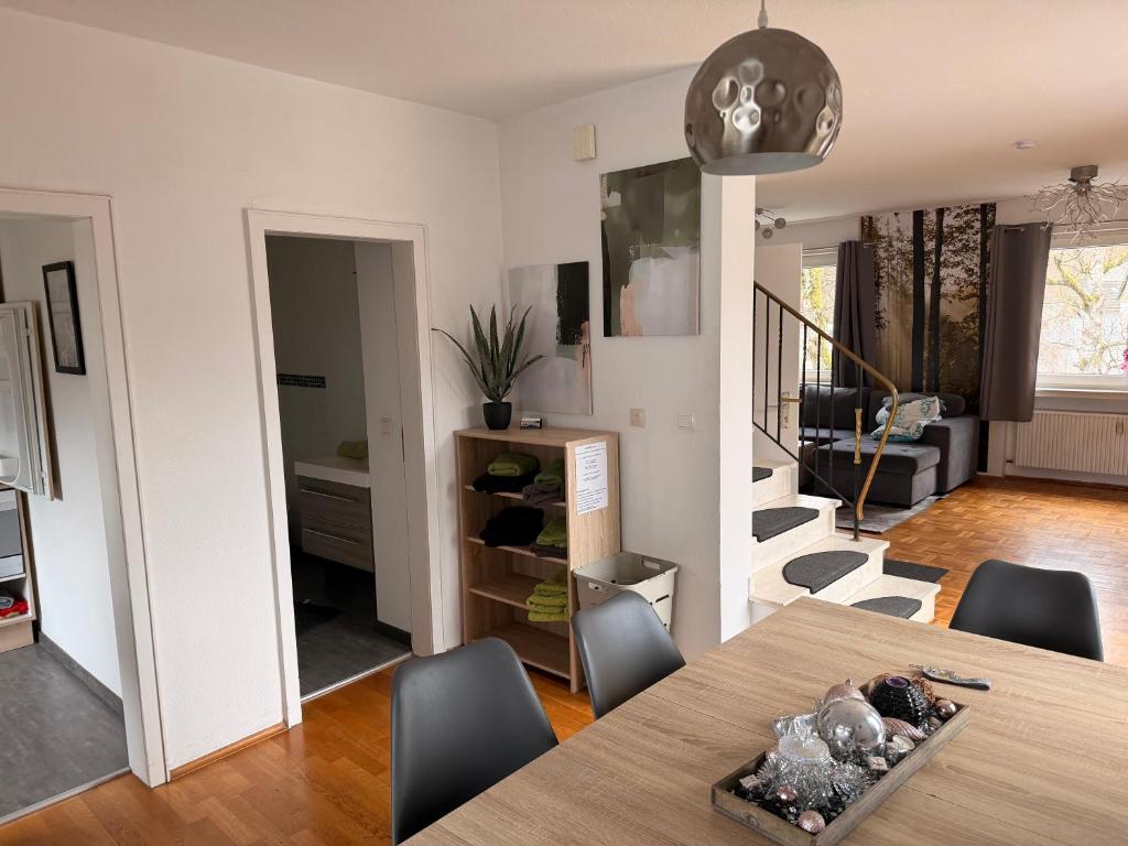 a dining room and living room with a table and chairs at Fewo Zentral in Willingen