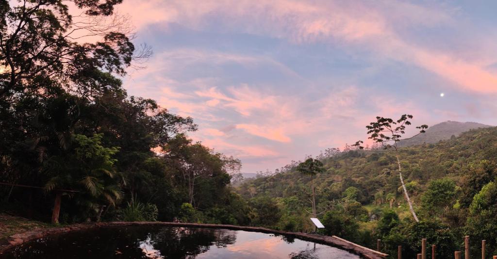 a pool of water in the middle of a mountain at A casa da Floresta in Florianópolis