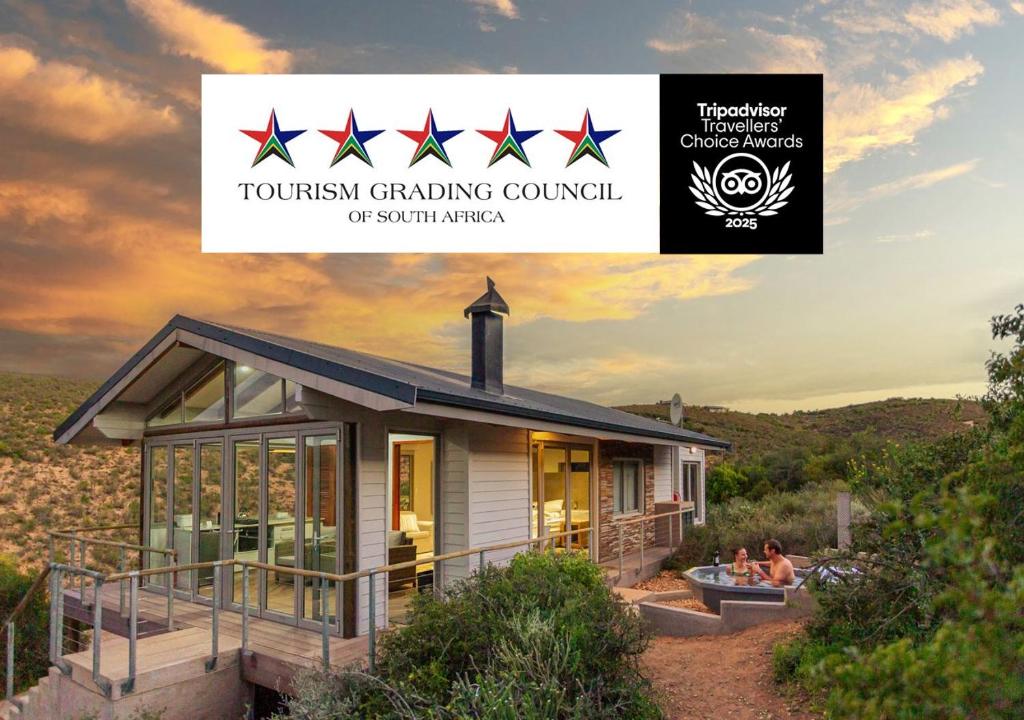 a house with a sign that reads tourism generating council at Landrani Luxury Lodge in Oudtshoorn