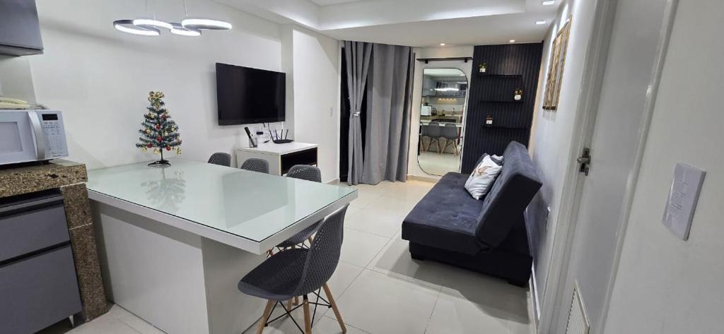 a kitchen with a counter and a living room at Marinas Flat 420 in João Pessoa