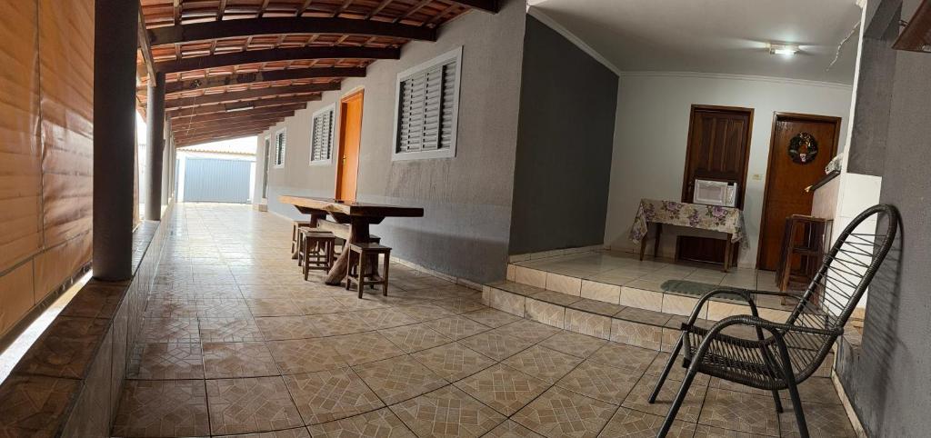a hallway with a table and chairs in a building at Suítes Santa Luzia in Trindade