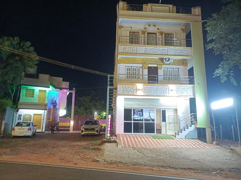a building with cars parked in front of it at night at Guru Residency Pondicherry in Puducherry
