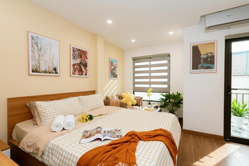 a bedroom with a large bed with shoes on it at Aurelia Aparthotel Hanoi in Hanoi