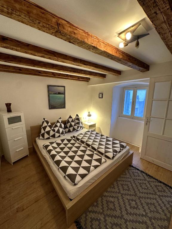 a bedroom with a large bed with a checkerboard at Stone house Anja in Vrbnik