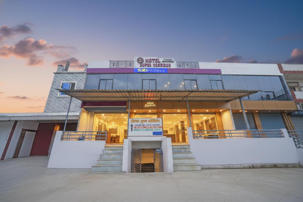 a building with a front entrance with stairs in front at FabHotel Super Corridor 