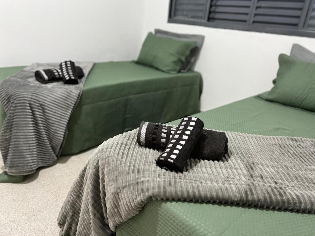 En eller flere senge i et værelse på Acolhedora casa de 03 quartos