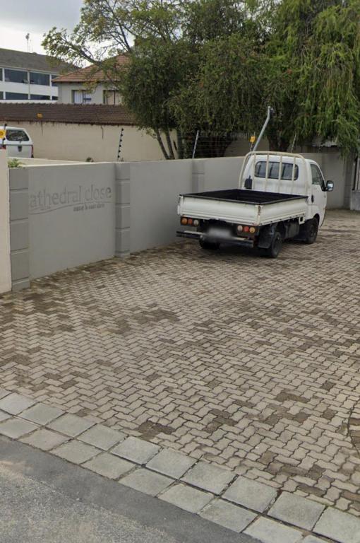 a white truck parked next to a fence at Da Silva Apartment in George