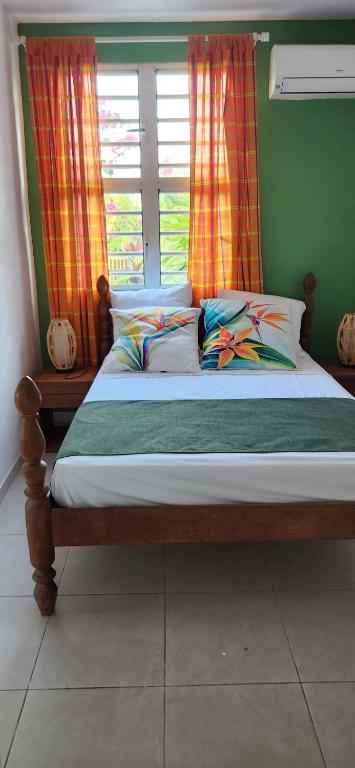 a bed sitting in a room with a window at Superbe T3 avec une grande terrasse et un accès direct aux 2 plages Gros Raisin in Sainte-Luce