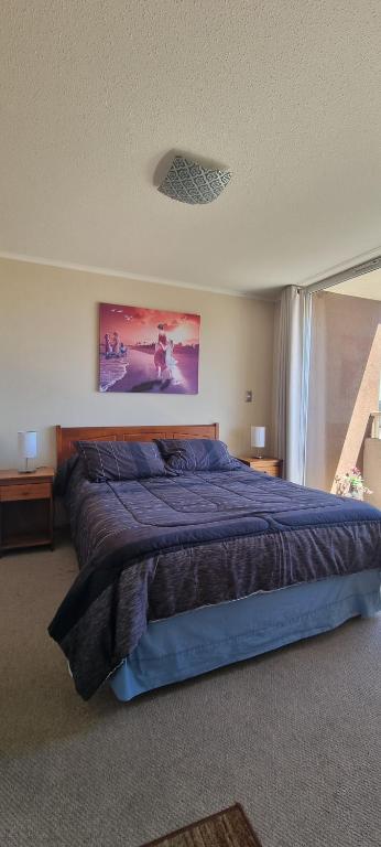 En eller flere senge i et værelse på Departamento completo, centrico y estacionamiento