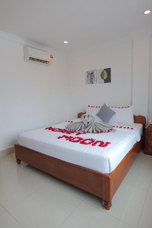 Ένα ή περισσότερα κρεβάτια σε δωμάτιο στο White Corner Hotel