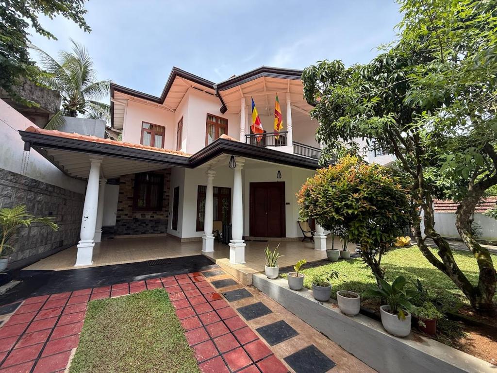 a house with two flags on top of it at Ceylon Villa in Matara
