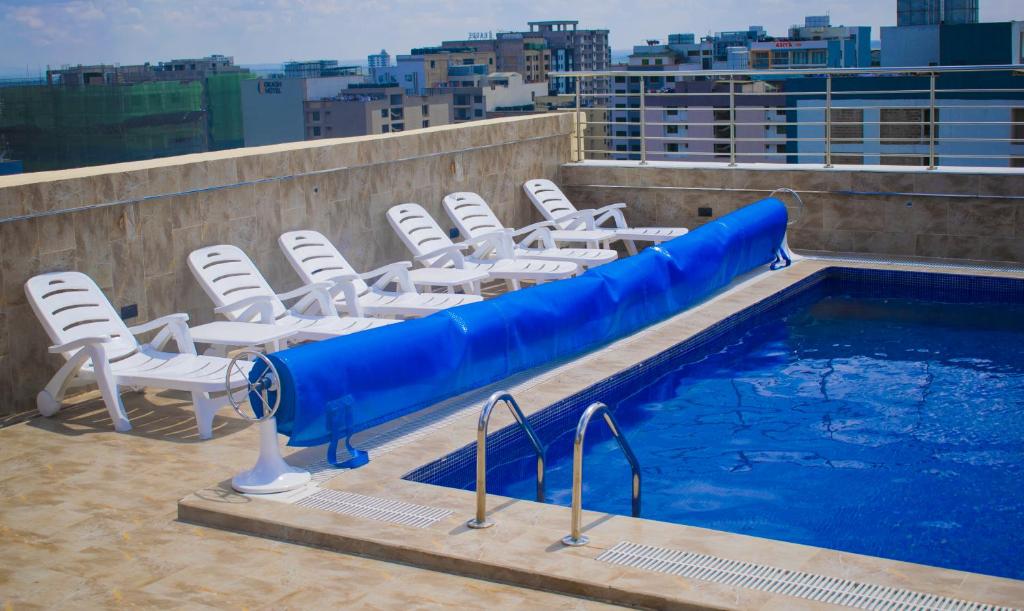 a pool with a blue water slide on a rooftop at Alya Hotel & Suites Ltd in Nairobi