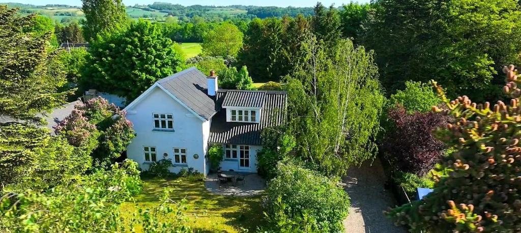 an aerial view of a white house surrounded by trees at Idyllic Country House Overlooking Svanninge Hills in Millinge