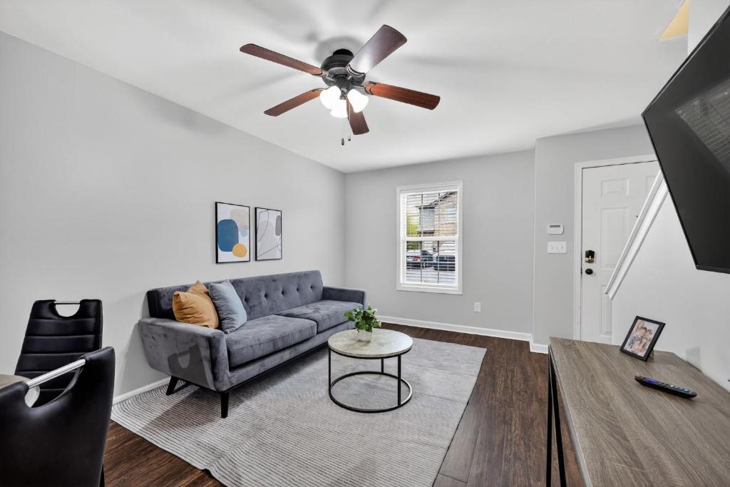 a living room with a couch and a ceiling fan at Inviting 2BR hideaway with contemporary touches in Clarksville