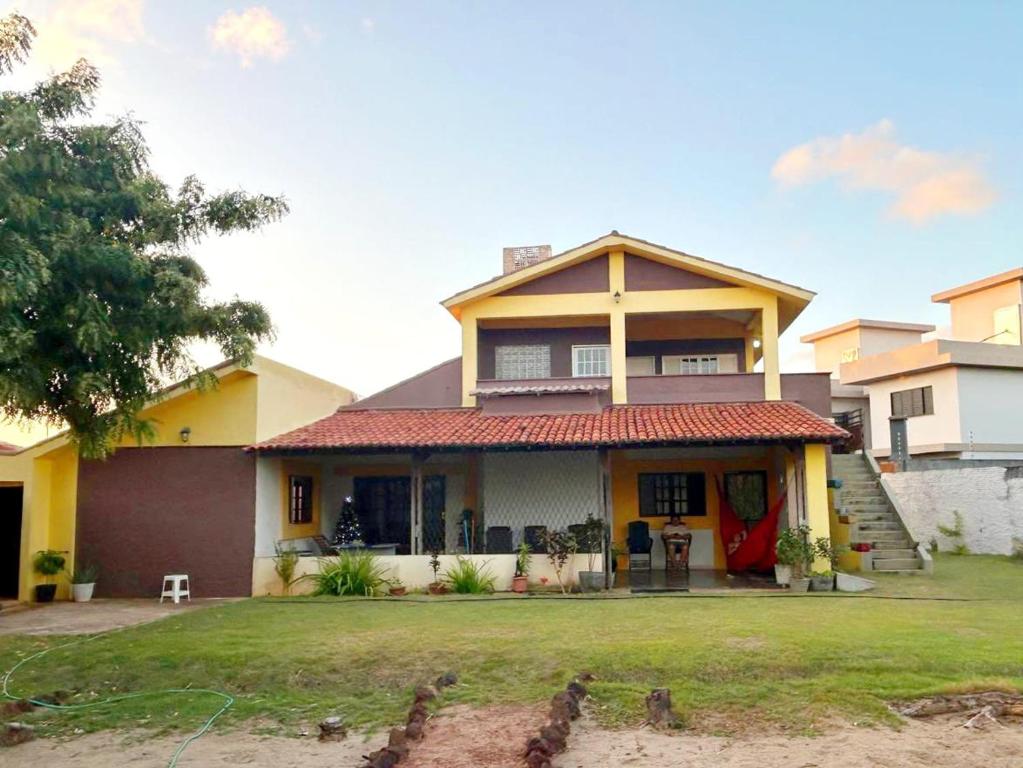 a house with a red roof at Pé na Terra - Suítes in São Miguel do Gostoso
