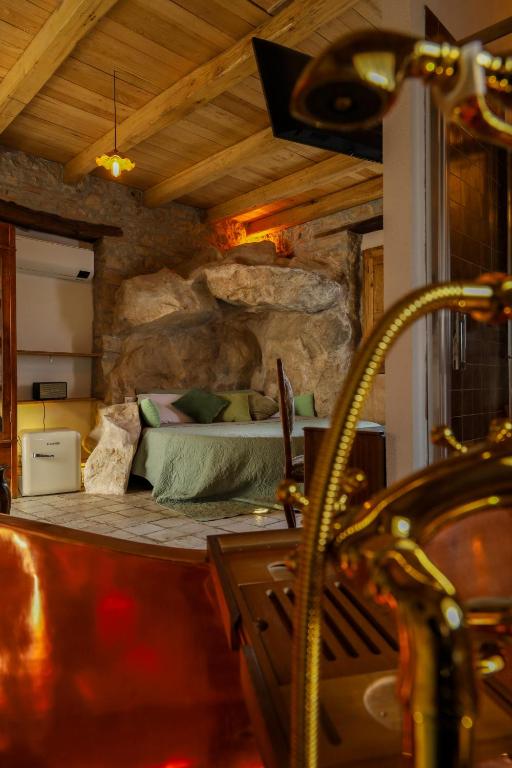 a bedroom with a bed in a rock wall at Paolino848 in Trentinara