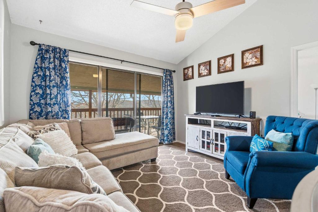 a living room with a couch and a tv at Ozark Overlook Escape - For 6 in Branson West