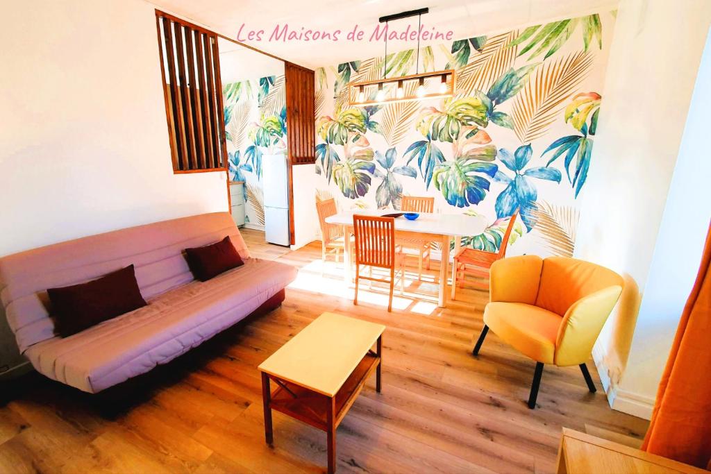 a living room with a couch and a table at L'Ecrin Marin Centre historique Plage à 5 min in Le Croisic