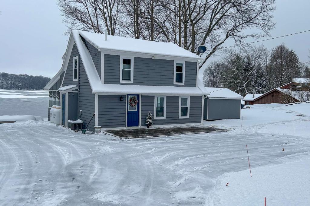 a house is covered in snow with a driveway at half Mi to Song Mountain Resort Ski Getaway! in Tully