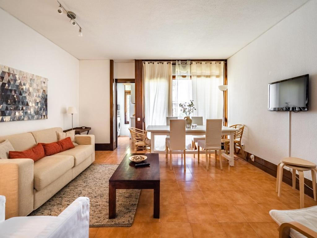 a living room with a couch and a table at Akisol Troia Apricot in Troia