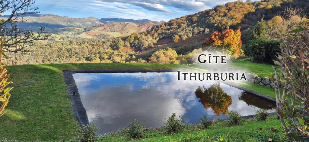 a lake in a field with the words cite indiopula at Ferme Ithurburia in Saint-Michel