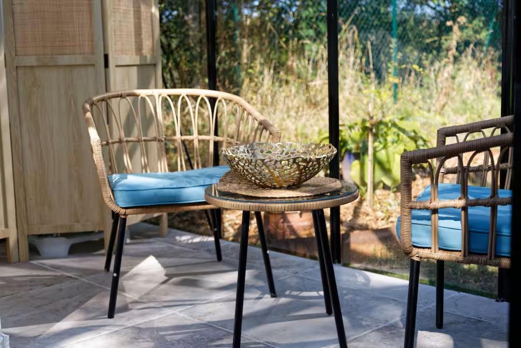 a bowl sitting on a table next to a chair at Domaine des pins A la belle étoile 