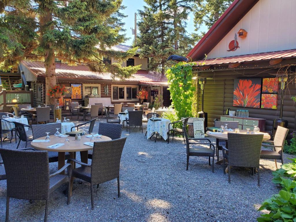 a restaurant with tables and chairs in front of a building at Laughing Horse Lodge in Bigfork