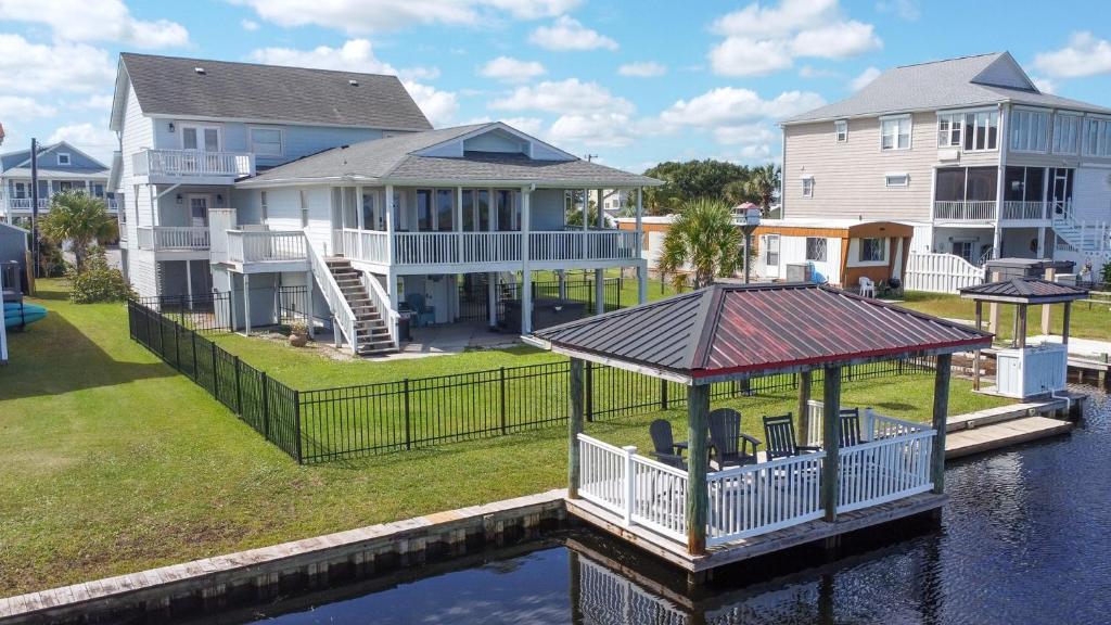 a house on the water with a gazebo at Dig'n It in West Onslow Beach