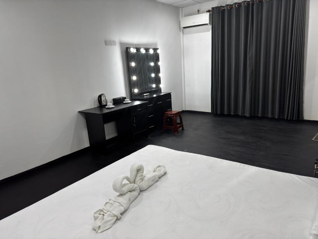 En eller flere senge i et værelse på Amore Beach Resort