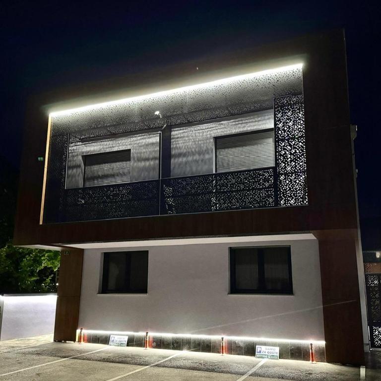 a building with lights on top of it at night at Apartmani Deluxe in Sanski most