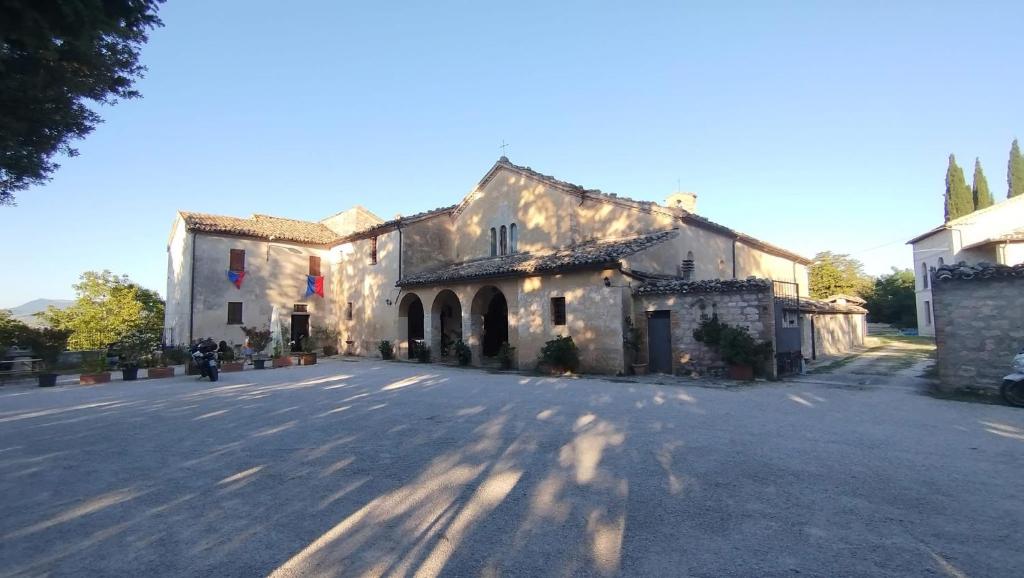 a large stone building on a street at Il Cantico in Cagli