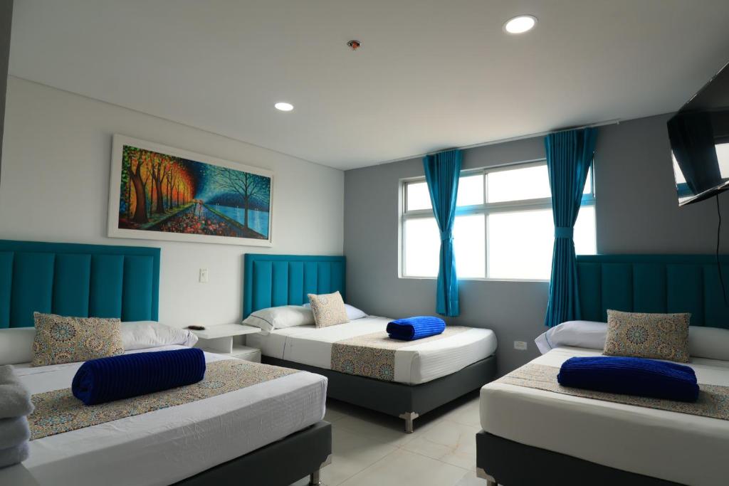 Postel nebo postele na pokoji v ubytování El Oscar Hotel