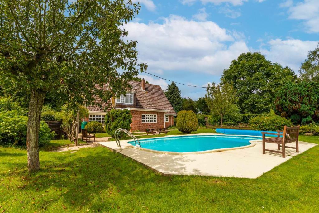 a swimming pool in the yard of a house at Alderfen View by Leap Escapes in Worstead
