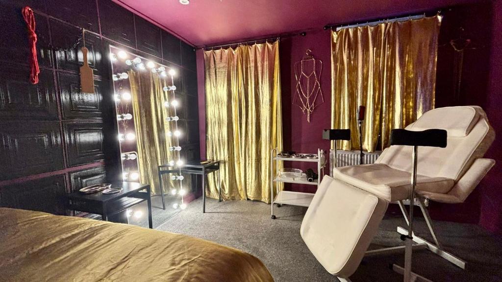 a bedroom with a bed and a chair and a desk at Designer Fantasy Den Boutique Seafront in Brighton & Hove